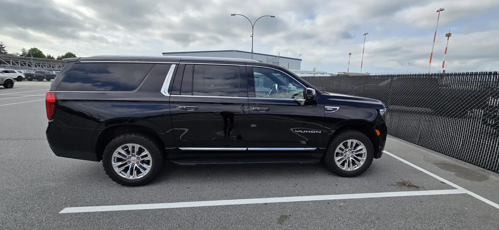 Black GMC Yukon parked in an outdoor parking area